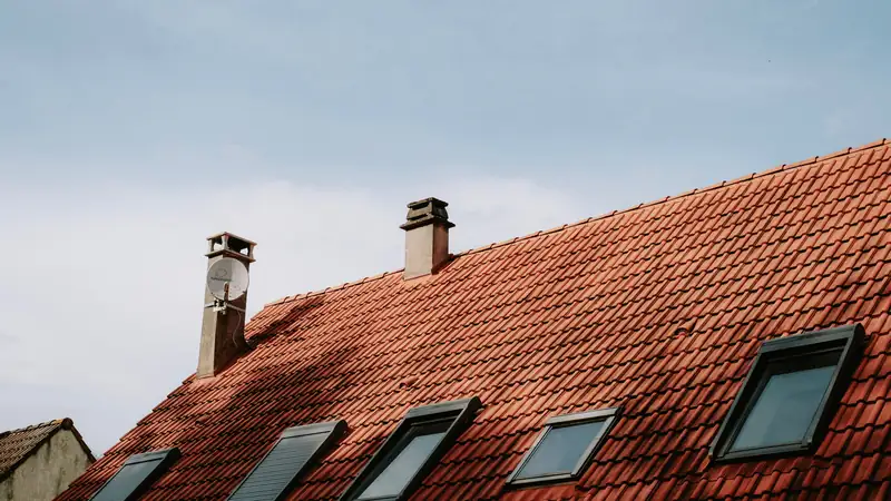 Toit en tuiles rouges équipé de plusieurs fenêtres de toit